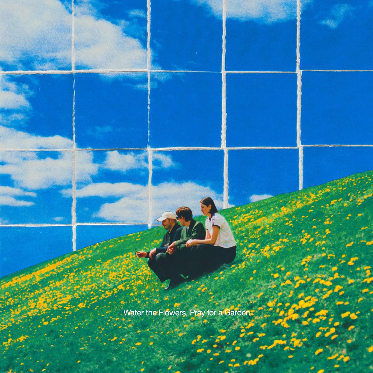 Three friends sitting on a hillside beneath a painted sky